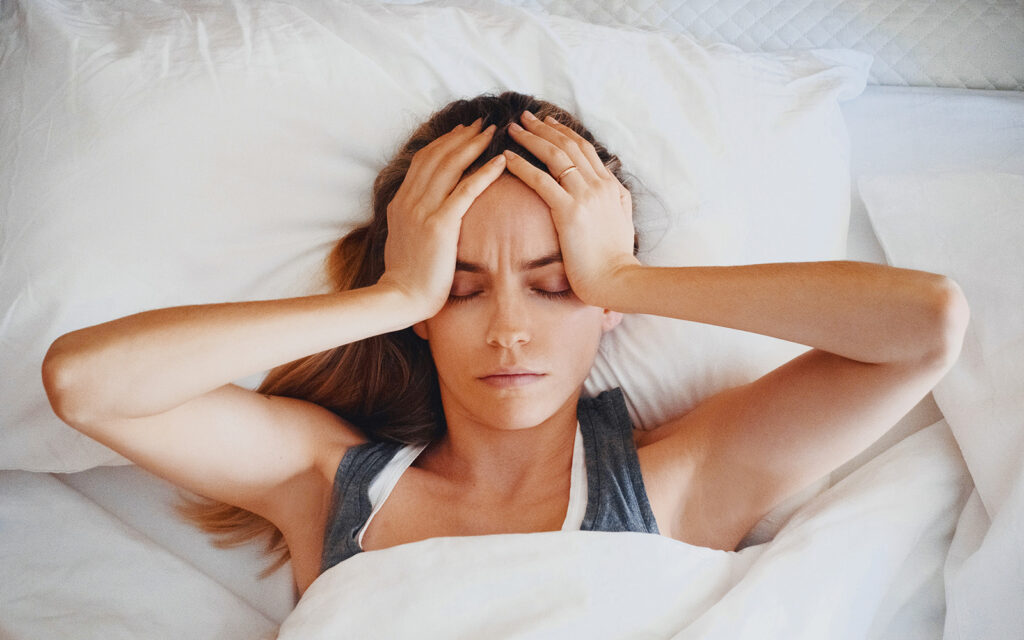 Woman stressed, hands on head
