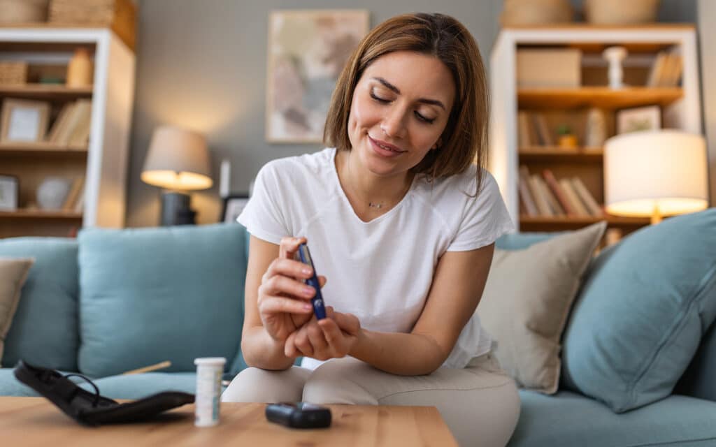 Woman testing her blood sugar levels with a device